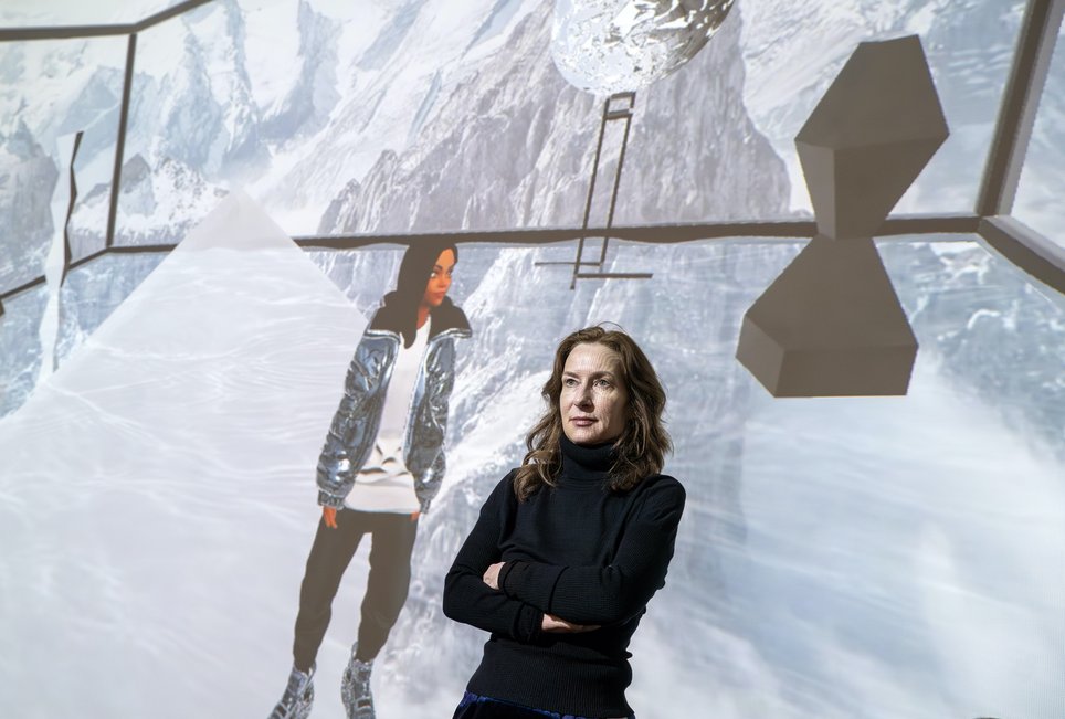 Josephine Meckseper stands in front of the gallery wall