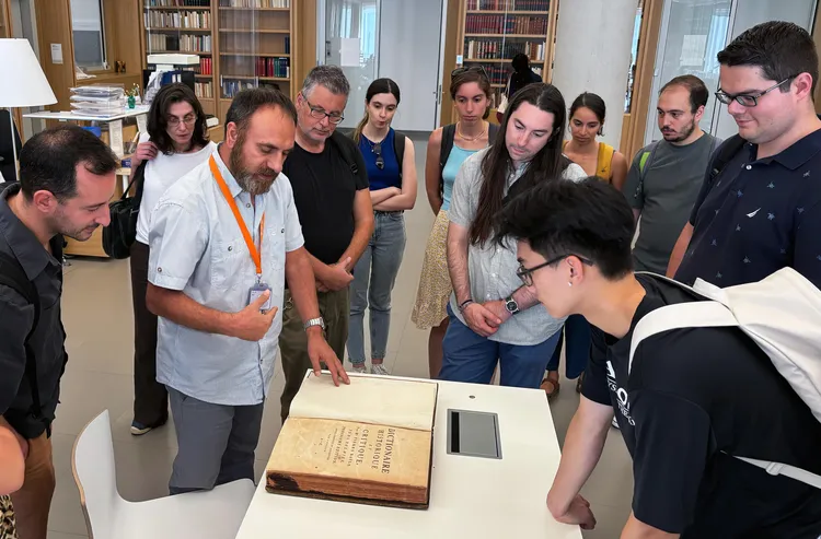 People gather around a book