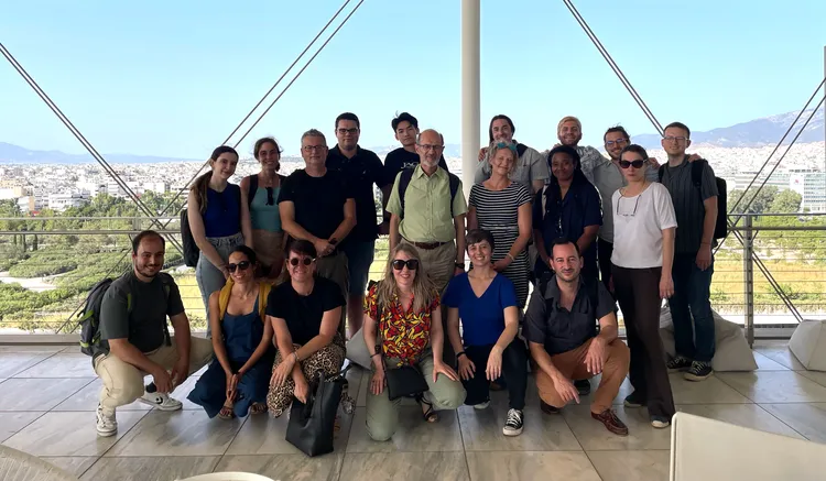 Participants and instructors stand together for a photo