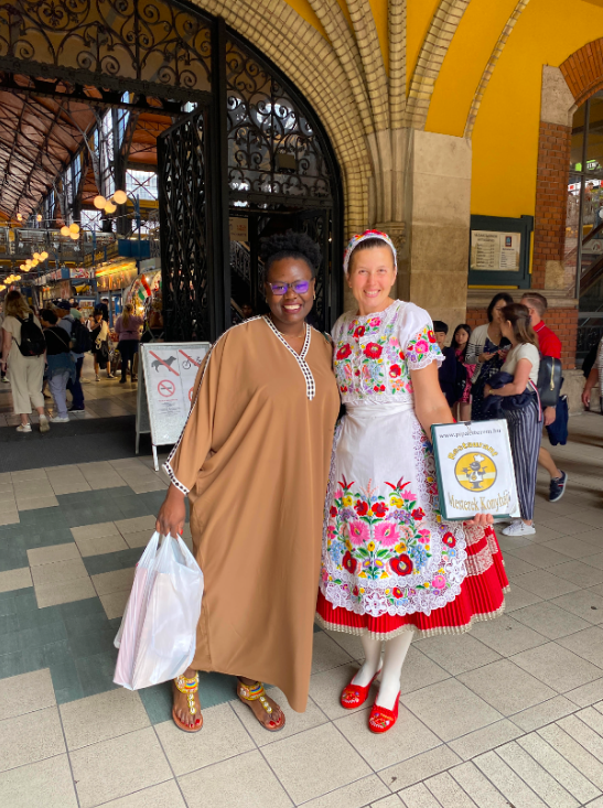 The author stands with a woman in traditional dress