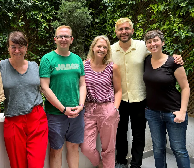 Five instructors stand together