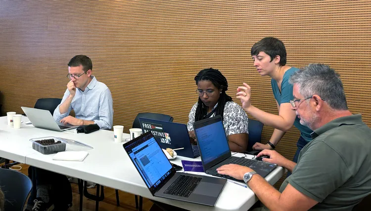 A group of people work on computers