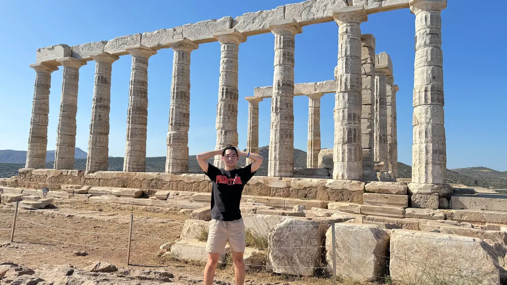 Man stands in front of ruins